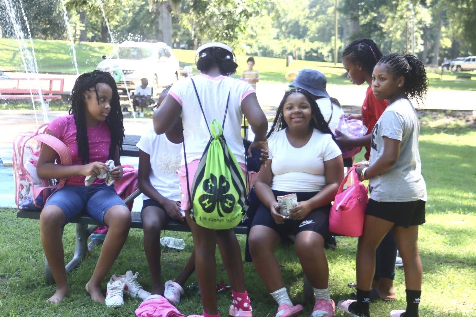 A group of kids sitting on a bench.